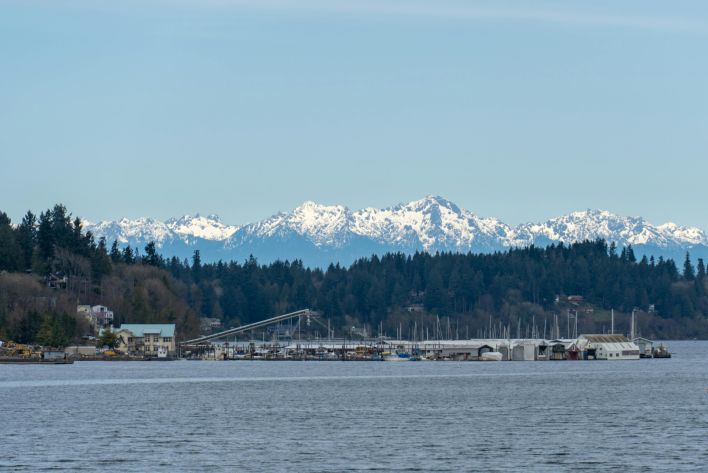 Scenic view of the snow-capped Olympic Mountains and marina over Puget Sound in Washington State.